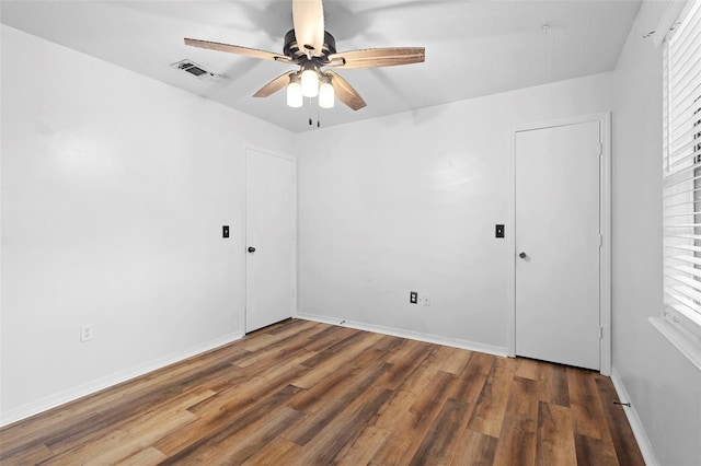 1106 Alpine Ave NW, Palm Bay, FL 32907 - spare room featuring wood finished floors, a ceiling fan, baseboards, and healthy amount of natural light