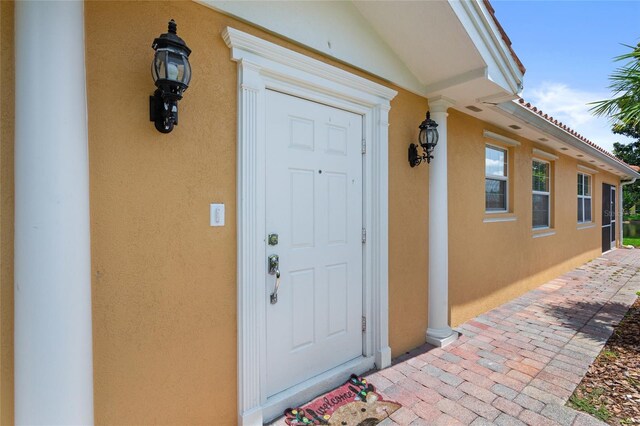 11863 Delfina Ln, Orlando, FL 32827 - view of exterior entry featuring stucco siding