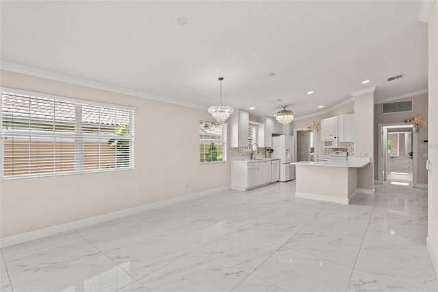 11863 Delfina Ln, Orlando, FL 32827 - kitchen with white appliances, a chandelier, crown molding, baseboards, and light marble finish flooring