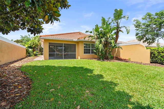 11863 Delfina Ln, Orlando, FL 32827 - back of house with stucco siding, a sunroom, and a tiled roof