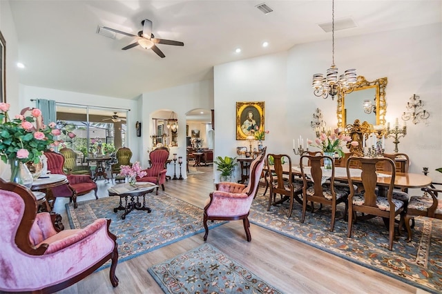 8721 Crystal Creek Ct, Land O Lakes, FL 34638 - living area featuring ceiling fan, arched walkways, wood finished floors, a chandelier, and recessed lighting