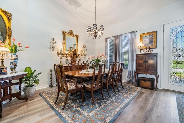 8721 Crystal Creek Ct, Land O Lakes, FL 34638 - dining area with a chandelier, healthy amount of natural light, light wood-style floors, baseboards, and vaulted ceiling