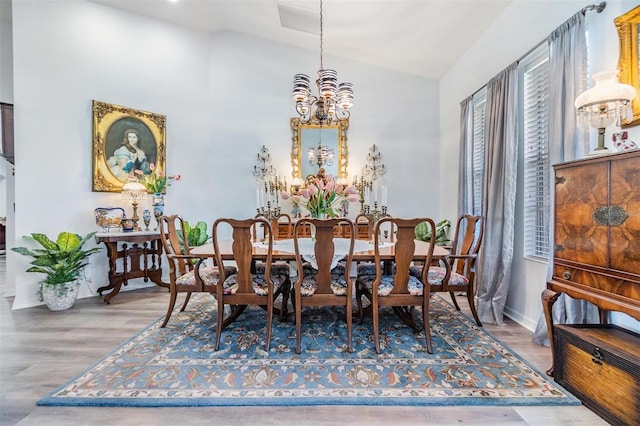 8721 Crystal Creek Ct, Land O Lakes, FL 34638 - dining space with a chandelier, wood finished floors, baseboards, and high vaulted ceiling