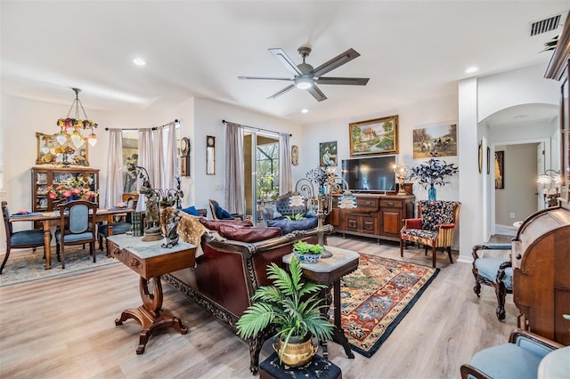 8721 Crystal Creek Ct, Land O Lakes, FL 34638 - living area with light wood-style flooring, arched walkways, ceiling fan, and recessed lighting