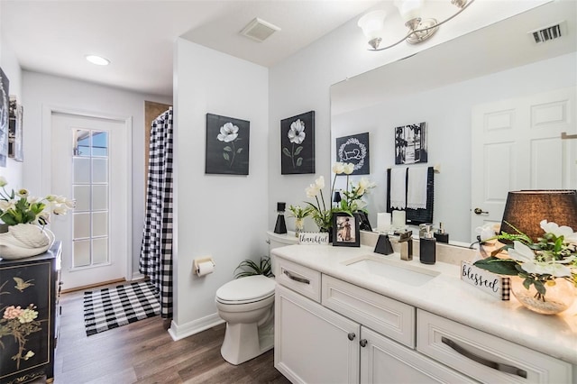 8721 Crystal Creek Ct, Land O Lakes, FL 34638 - bathroom featuring wood finished floors, toilet, vanity, a shower with curtain, and baseboards