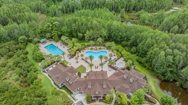 8721 Crystal Creek Ct, Land O Lakes, FL 34638 - aerial view of property's location with a pool area, a forest, and a nearby body of water