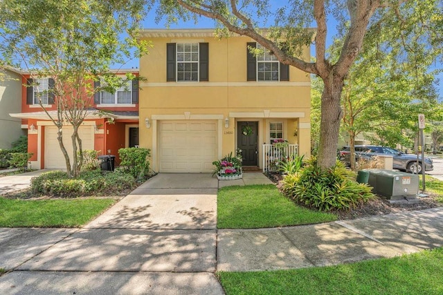 13480 Applerose Ln Unit 19, Orlando, FL 32824 - townhome / multi-family property featuring a garage, stucco siding, and driveway