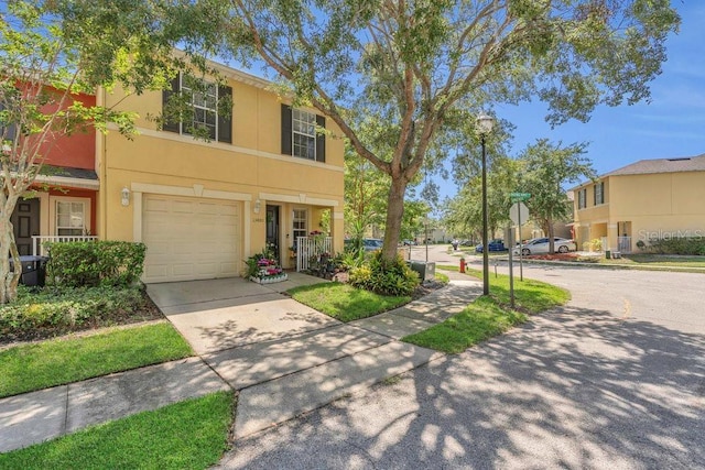 13480 Applerose Ln Unit 19, Orlando, FL 32824 - multi unit property featuring stucco siding, an attached garage, and concrete driveway