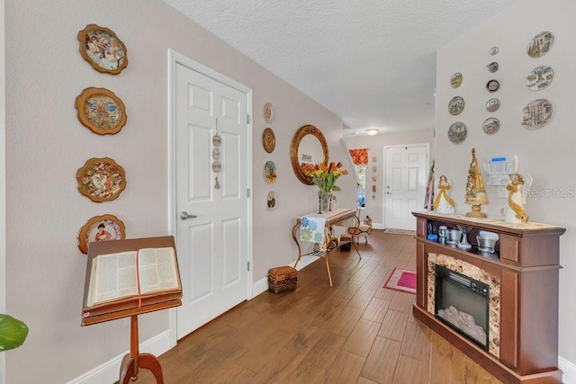 13480 Applerose Ln Unit 19, Orlando, FL 32824 - foyer entrance with wood finished floors, baseboards, and a textured ceiling