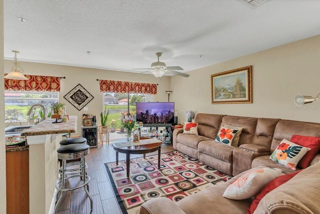 13480 Applerose Ln Unit 19, Orlando, FL 32824 - living room with ceiling fan, a textured ceiling, and wood finished floors