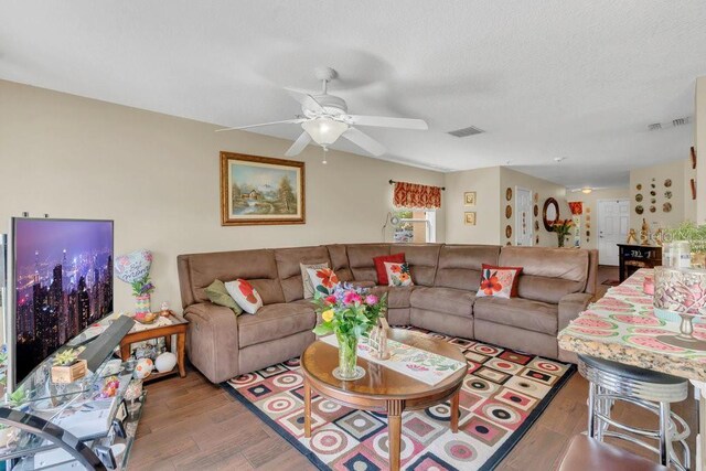 13480 Applerose Ln Unit 19, Orlando, FL 32824 - living area featuring wood finished floors, a ceiling fan, and a textured ceiling