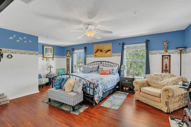 13480 Applerose Ln Unit 19, Orlando, FL 32824 - bedroom featuring wood finished floors, multiple windows, a textured ceiling, and a ceiling fan