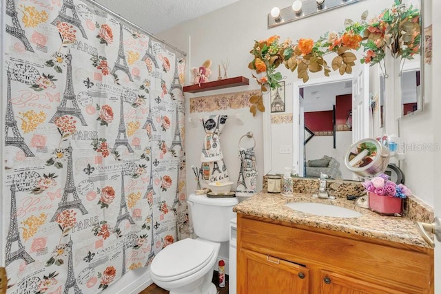 13480 Applerose Ln Unit 19, Orlando, FL 32824 - full bath featuring toilet, vanity, a textured ceiling, and a shower with curtain
