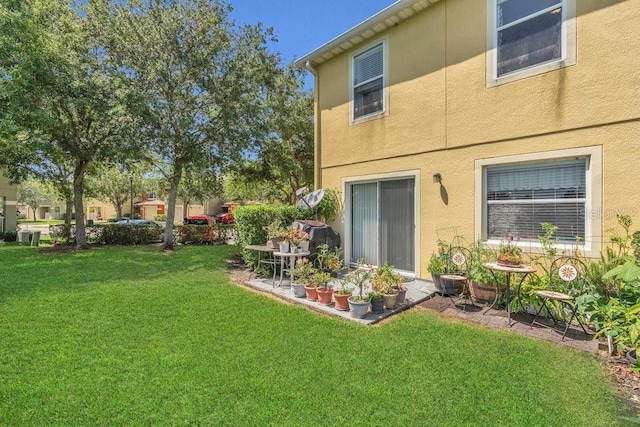 13480 Applerose Ln Unit 19, Orlando, FL 32824 - view of green lawn with a patio area