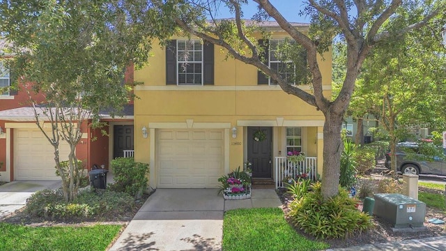13480 Applerose Ln Unit 19, Orlando, FL 32824 - multi unit property with concrete driveway, stucco siding, and a porch