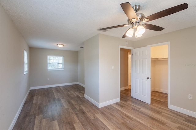 4827 Elese St, Orlando, FL 32811 - unfurnished room with wood finished floors, a textured ceiling, a ceiling fan, and baseboards