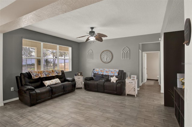 1744 Pine Ridge Dr, Davenport, FL 33896 - living room featuring a textured ceiling, ceiling fan, wood finished floors, and baseboards