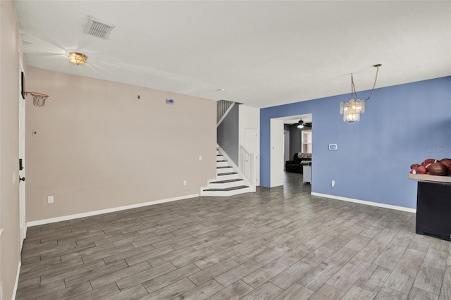 1744 Pine Ridge Dr, Davenport, FL 33896 - unfurnished living room with wood finished floors, a ceiling fan, stairway, and baseboards
