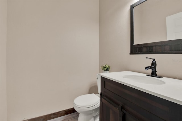 1744 Pine Ridge Dr, Davenport, FL 33896 - half bath featuring toilet, vanity, and baseboards
