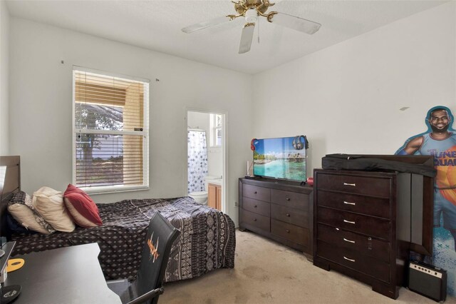 1744 Pine Ridge Dr, Davenport, FL 33896 - bedroom featuring light carpet, ensuite bathroom, and ceiling fan