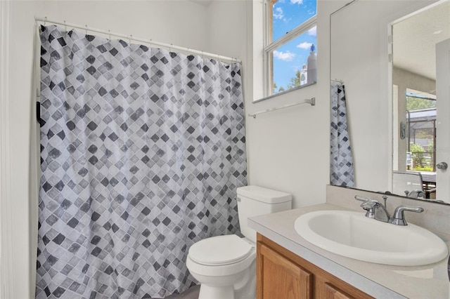 1744 Pine Ridge Dr, Davenport, FL 33896 - bathroom with toilet, vanity, and a shower with shower curtain
