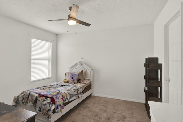 1744 Pine Ridge Dr, Davenport, FL 33896 - bedroom featuring carpet flooring, a textured ceiling, a ceiling fan, and baseboards