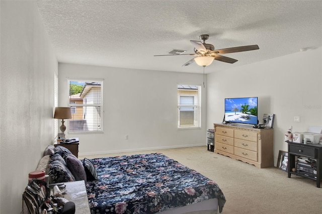 1744 Pine Ridge Dr, Davenport, FL 33896 - bedroom with multiple windows, light colored carpet, a textured ceiling, ceiling fan, and baseboards