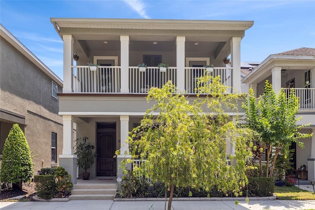 308 Michael Blake Blvd, Winter Springs, FL 32708 - view of front facade featuring a balcony, stucco siding, and a porch