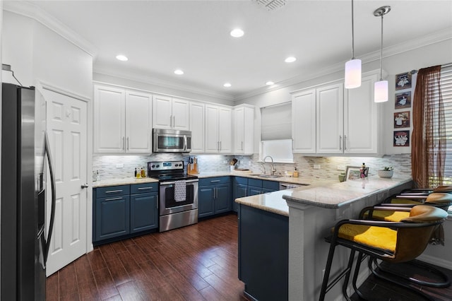 308 Michael Blake Blvd, Winter Springs, FL 32708 - kitchen featuring stainless steel appliances, blue cabinets, a peninsula, white cabinetry, and dark wood-type flooring