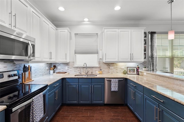 308 Michael Blake Blvd, Winter Springs, FL 32708 - kitchen with stainless steel appliances, a sink, blue cabinets, ornamental molding, and white cabinetry
