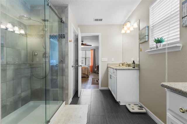 308 Michael Blake Blvd, Winter Springs, FL 32708 - full bathroom with vanity, ensuite bathroom, a stall shower, baseboards, and a textured ceiling
