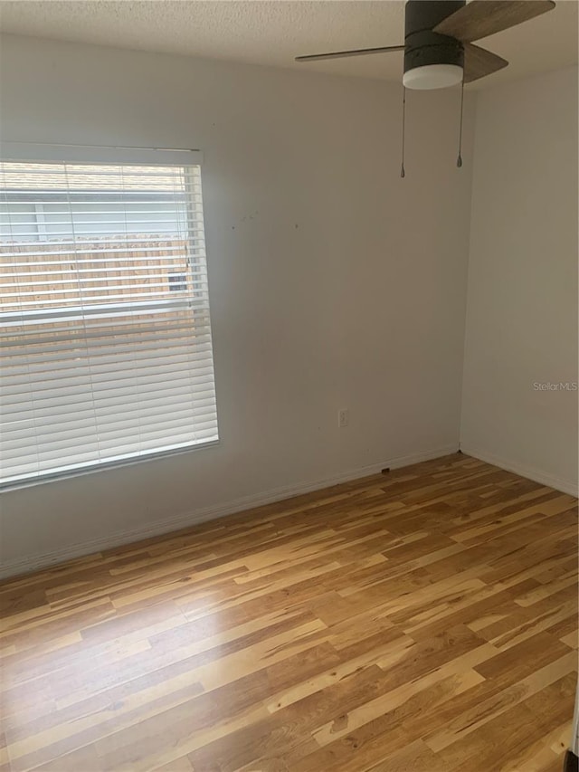 701 Twin Lake Ave, Deltona, FL 32738 - spare room with ceiling fan, light wood finished floors, baseboards, and a textured ceiling
