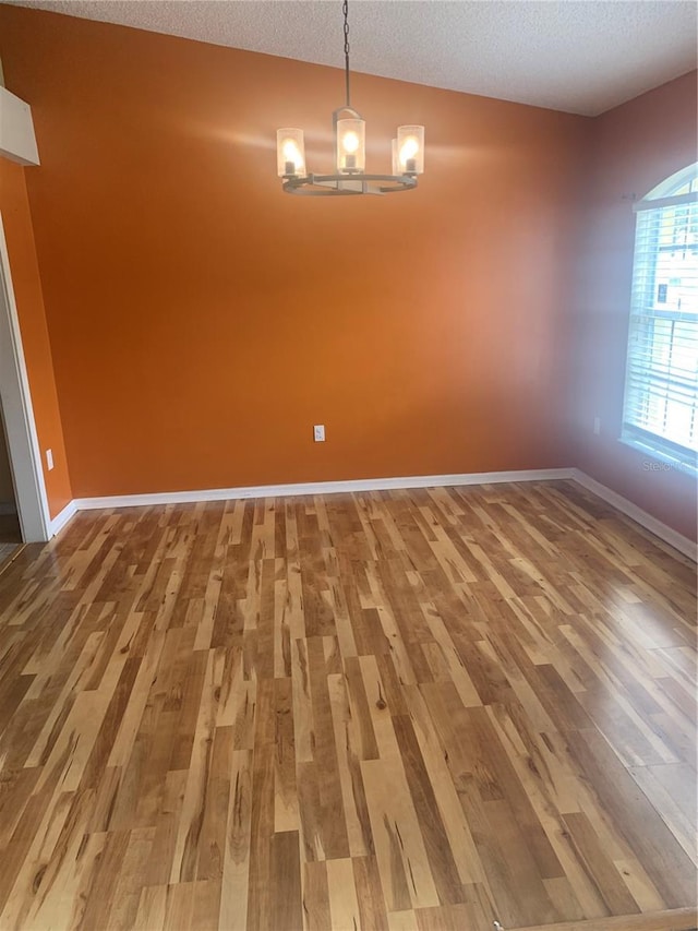 701 Twin Lake Ave, Deltona, FL 32738 - empty room with wood finished floors, a textured ceiling, and baseboards