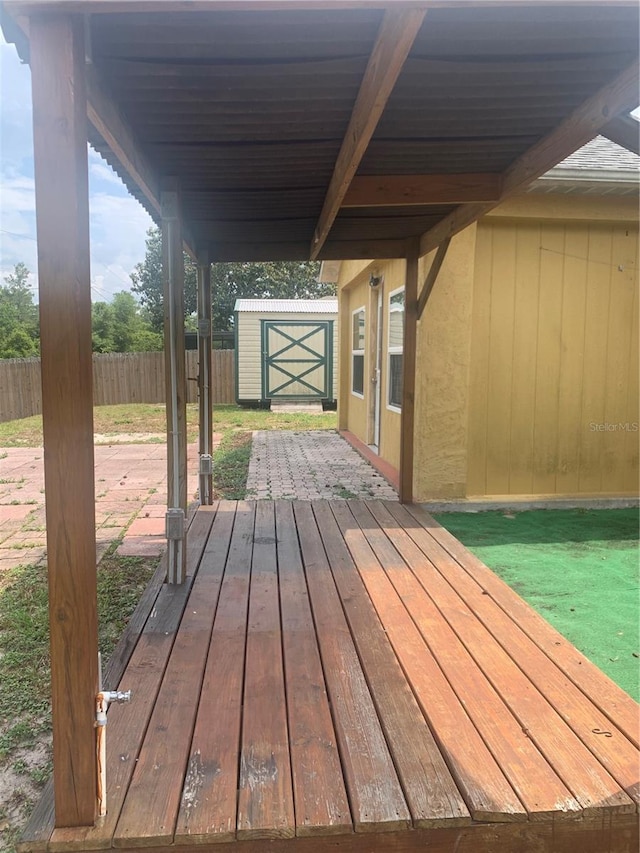 701 Twin Lake Ave, Deltona, FL 32738 - deck featuring fence, a storage shed, and an outbuilding