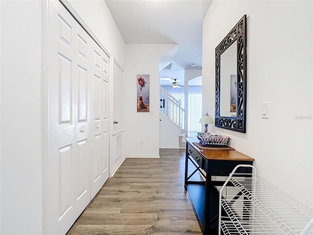 hall featuring wood finished floors and baseboards