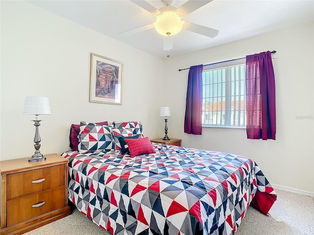 carpeted bedroom with a ceiling fan and baseboards