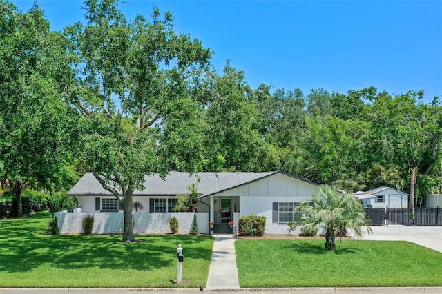 711 Valencia Ct, Winter Garden, FL 34787 - ranch-style house with concrete driveway, a gate, and board and batten siding