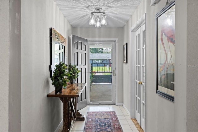 711 Valencia Ct, Winter Garden, FL 34787 - doorway featuring light tile patterned floors, a chandelier, and baseboards
