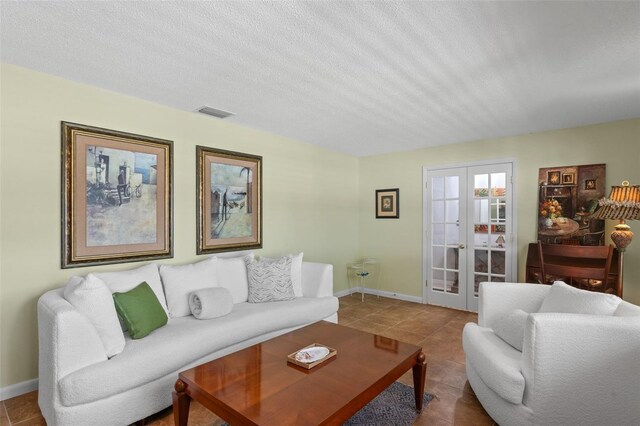 711 Valencia Ct, Winter Garden, FL 34787 - tiled living room featuring french doors, baseboards, and a textured ceiling