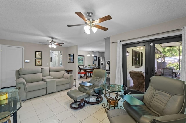 711 Valencia Ct, Winter Garden, FL 34787 - living area with french doors, a ceiling fan, light tile patterned floors, a textured ceiling, and plenty of natural light