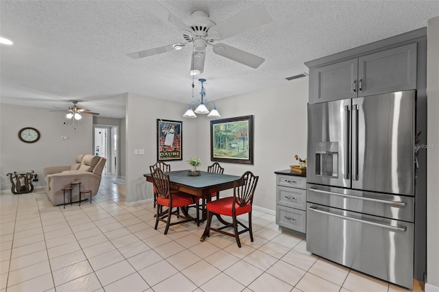 711 Valencia Ct, Winter Garden, FL 34787 - dining room featuring ceiling fan, a textured ceiling, light tile patterned flooring, and baseboards