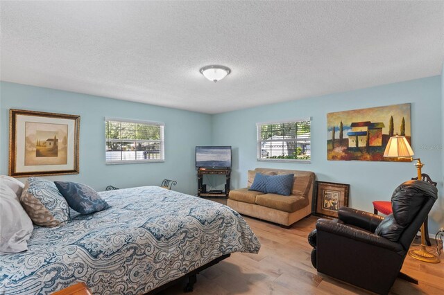 711 Valencia Ct, Winter Garden, FL 34787 - bedroom featuring wood finished floors and a textured ceiling