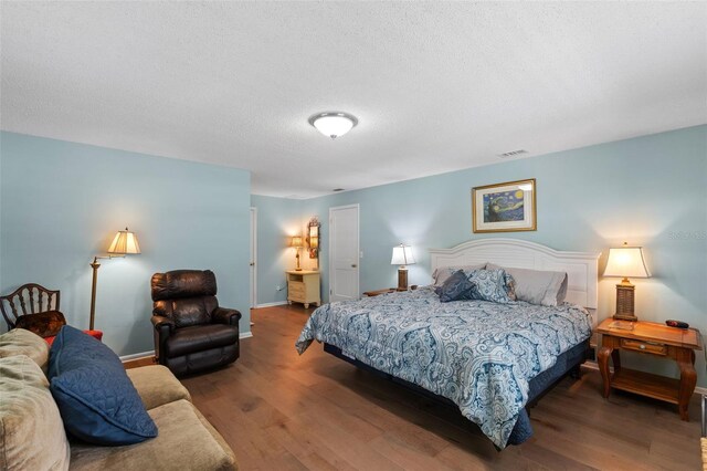 711 Valencia Ct, Winter Garden, FL 34787 - bedroom with wood finished floors, a textured ceiling, and baseboards