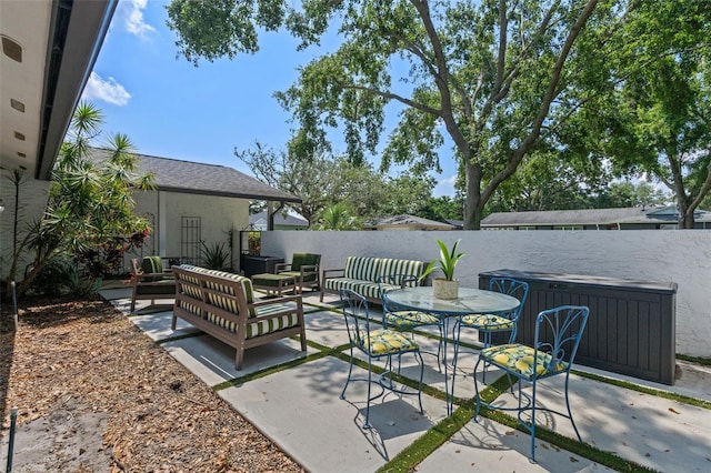 711 Valencia Ct, Winter Garden, FL 34787 - view of patio featuring a fenced backyard, outdoor lounge area, and a jacuzzi