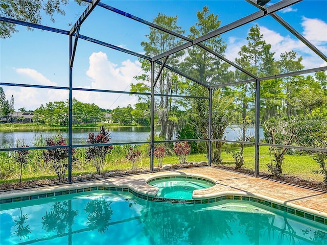 view of swimming pool featuring a water view, a lanai, and view of wooded area