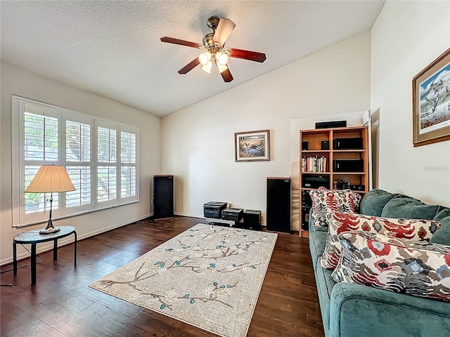 bedroom with lofted ceiling, dark wood-style floors, a textured ceiling, and baseboards