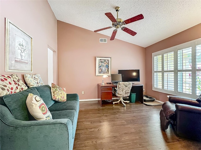 office area with vaulted ceiling, a textured ceiling, ceiling fan, wood finished floors, and baseboards