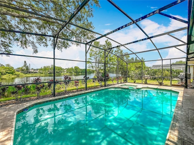 view of pool featuring a water view, glass enclosure, and a pool with connected hot tub