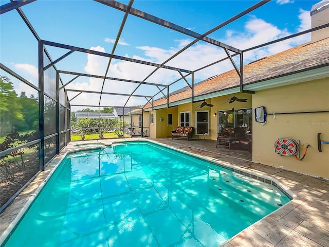 view of pool featuring a patio area, ceiling fan, a lanai, and a pool with connected hot tub