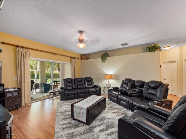 1319 Castleport Rd, Winter Garden, FL 34787 - living room featuring a ceiling fan, light wood-style flooring, and a textured ceiling
